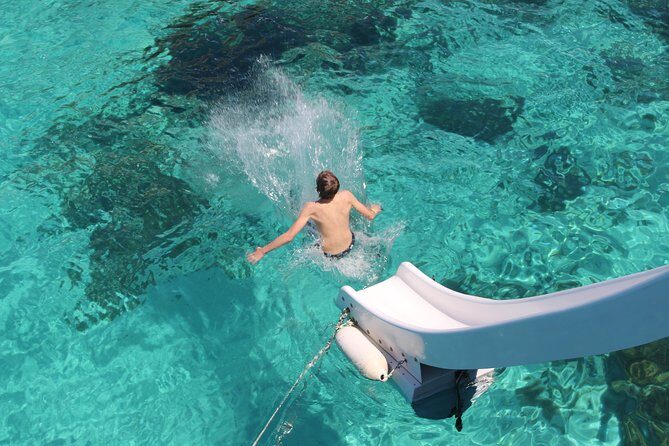 An afternoon sunset cruise to the Blue Lagoon - Onboard Perks: Loungers, Waterslides, and Catamaran Comfort