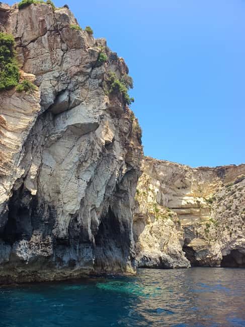 From Sliema: Blue Grotto Trip - Including Boat Cave Tour - Small boats and cave light: the real Blue Grotto moment