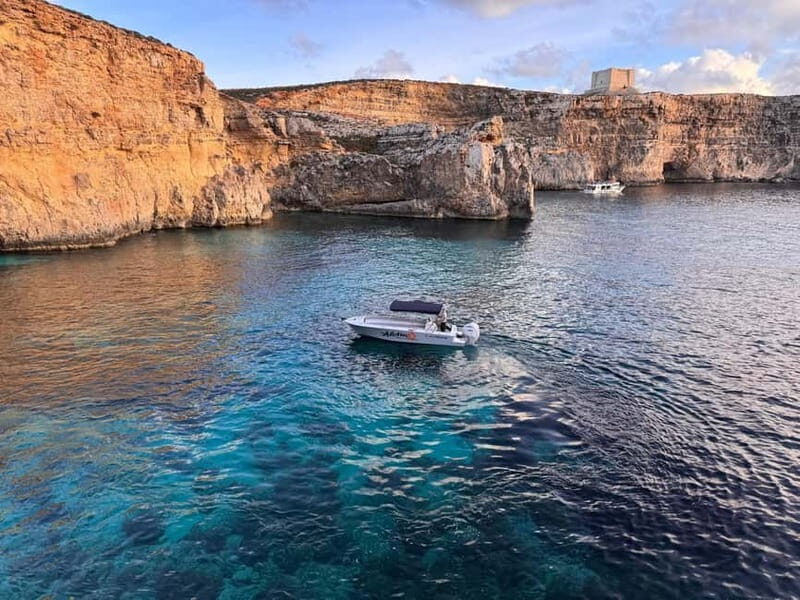 Malta: Blue Lagoon, Caves, Comino & Gozo Private Boat Trip - Santa Marija Tower and the coastline pass: history you can see from the water