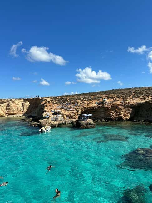 Malta: Gozo, Comino, Blue & Crystal Lagoon, & Caves Cruise - Passing Crystal Lagoon and Saint Mary’s Tower on the Return